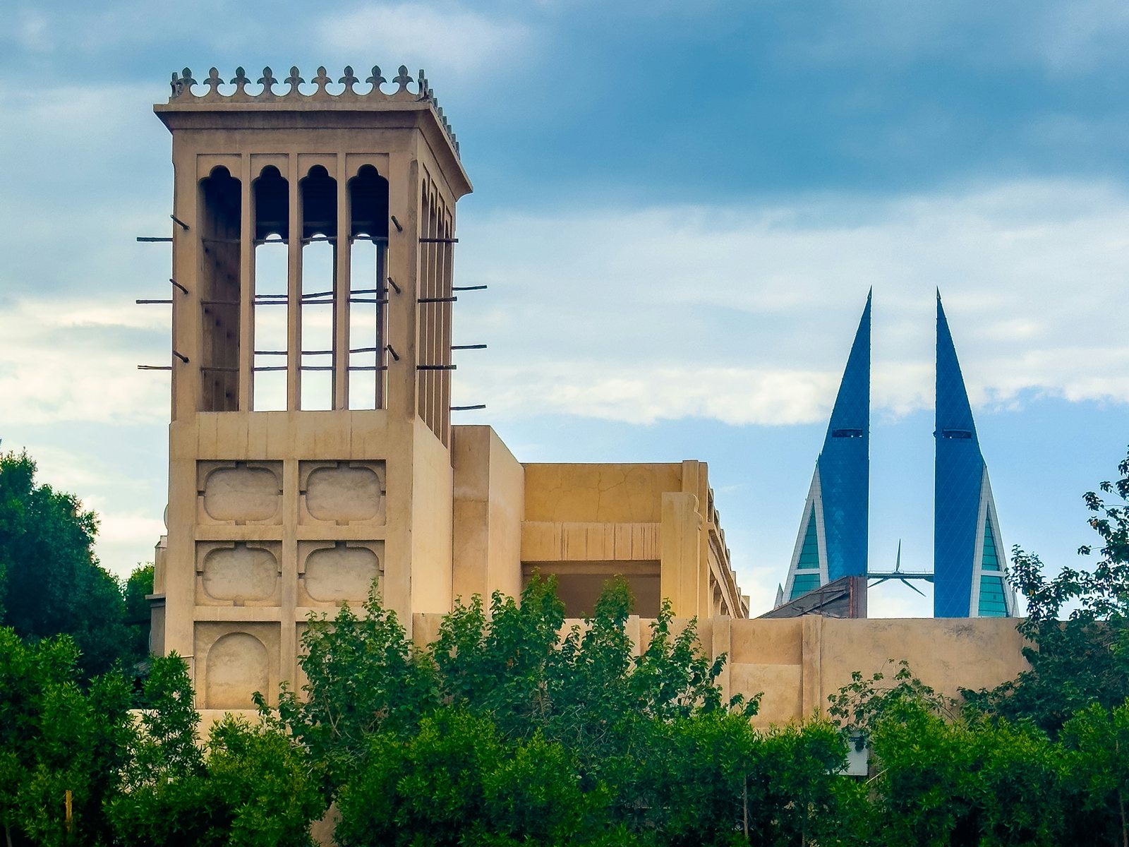 A traditional wind tower in Manama, with the Bahrain World Trade Center behind