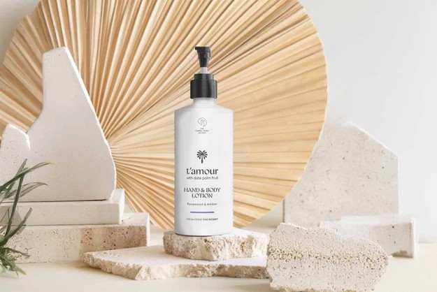 T&rsquo;amour hand and body lotion with date palm fruit, Rosewood and Amber, on limestone